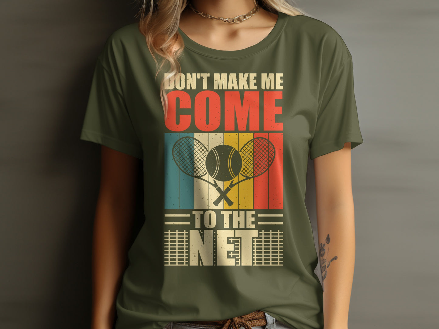 Green t-shirt with "Don't Make Me Come To The Net" and tennis rackets.