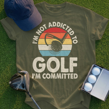 Olive t-shirt with "I'm Not Addicted To Golf I'm Committed" text and golf graphic.