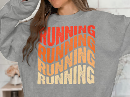 Gray sweatshirt with "Running" text in orange and yellow gradient.
