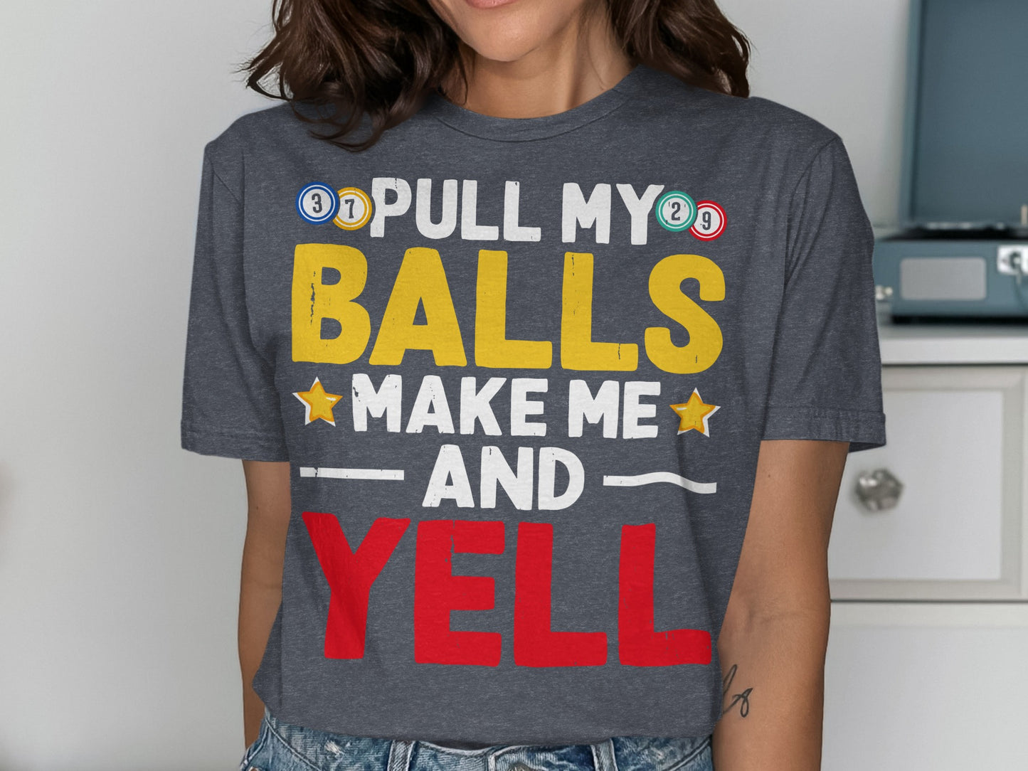 Dark grey t-shirt with text "PULL MY BALLS MAKE ME AND YELL".