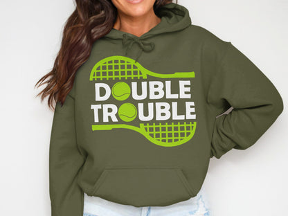Olive green hoodie with "DOUBLE TROUBLE" text and tennis racket and ball graphic.