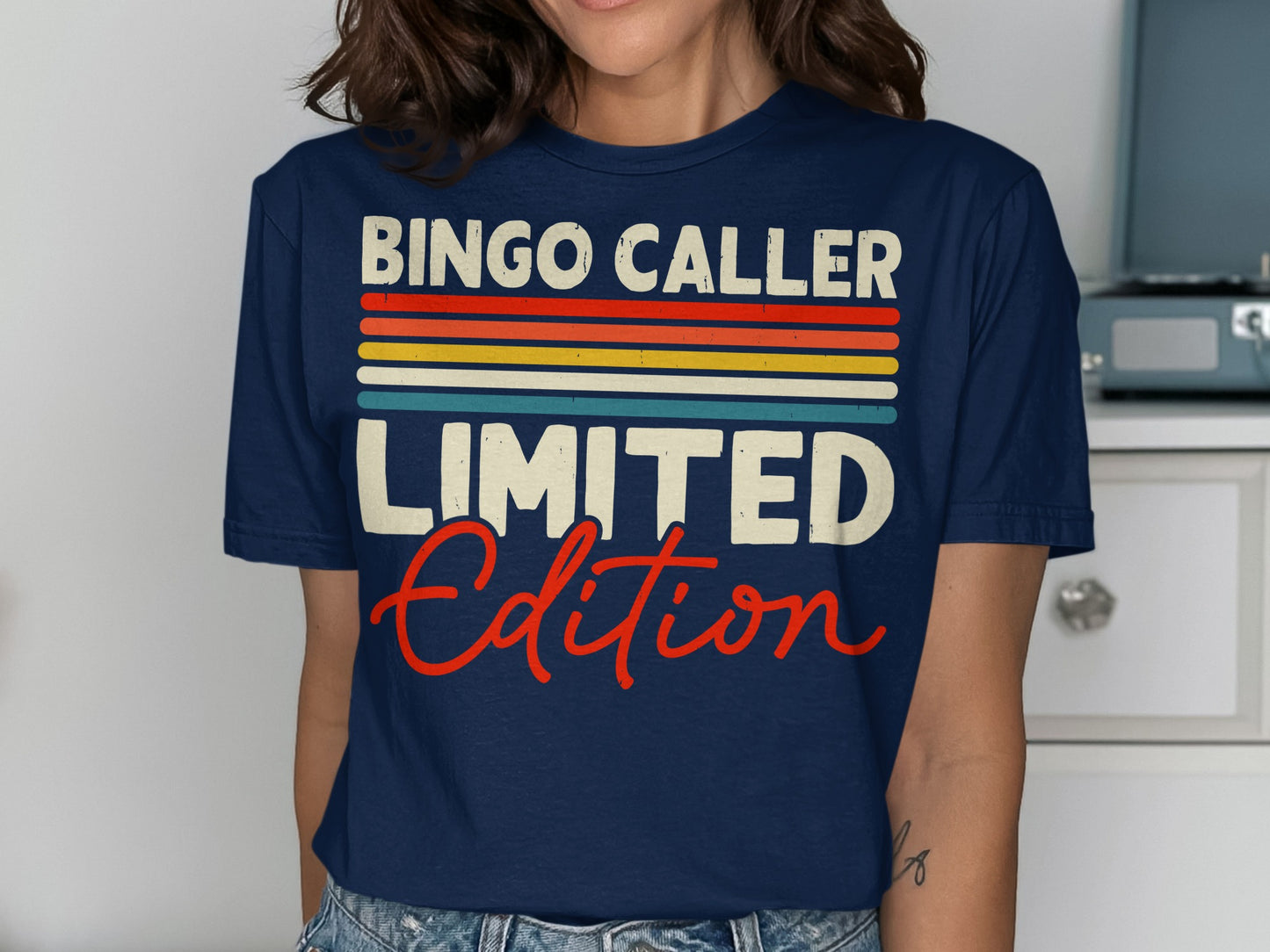 Navy t-shirt with "BINGO CALLER LIMITED EDITION" in colorful stripes and distressed text.