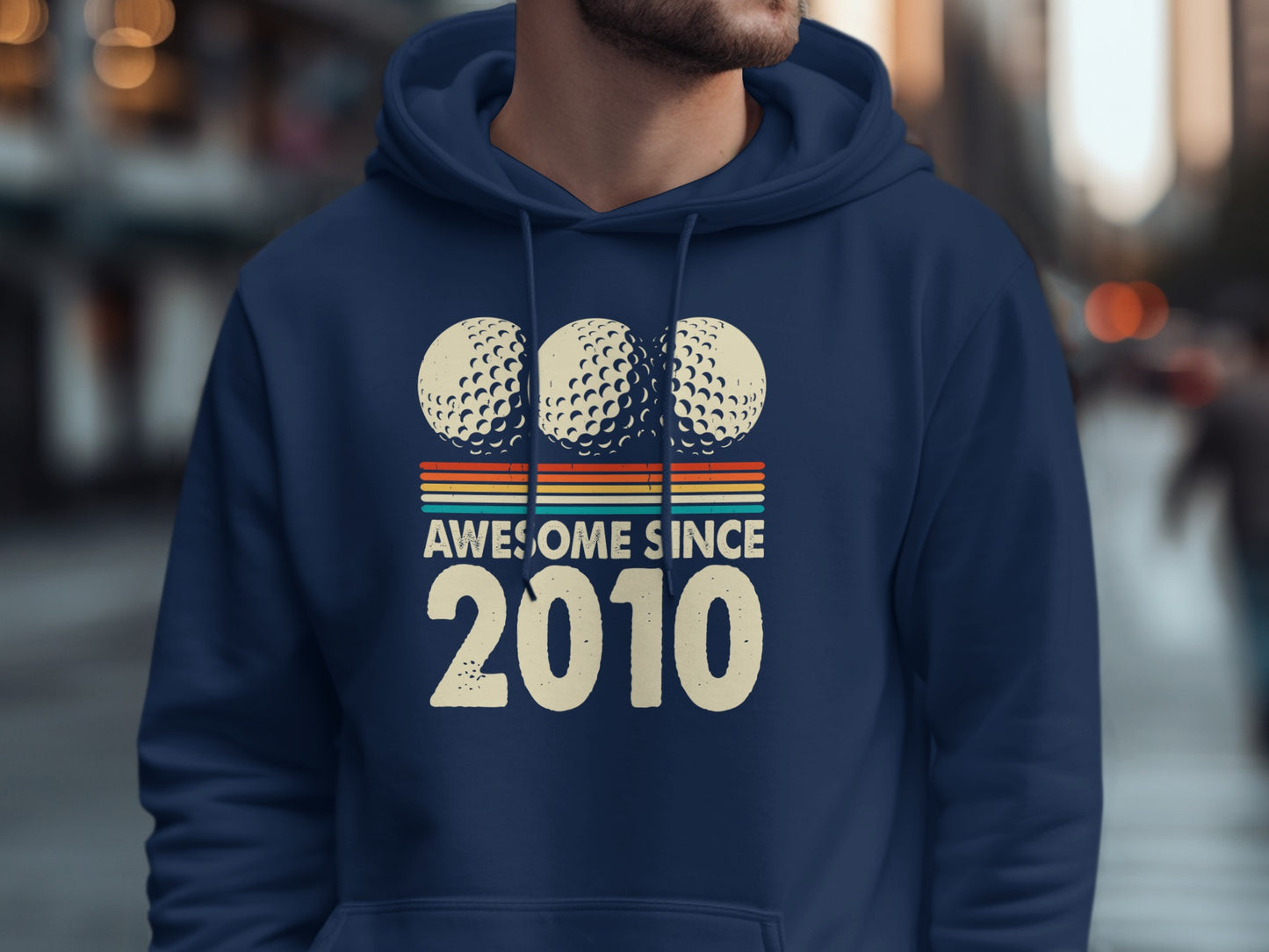 Navy hoodie with "Awesome Since 2010" text and three golf balls.