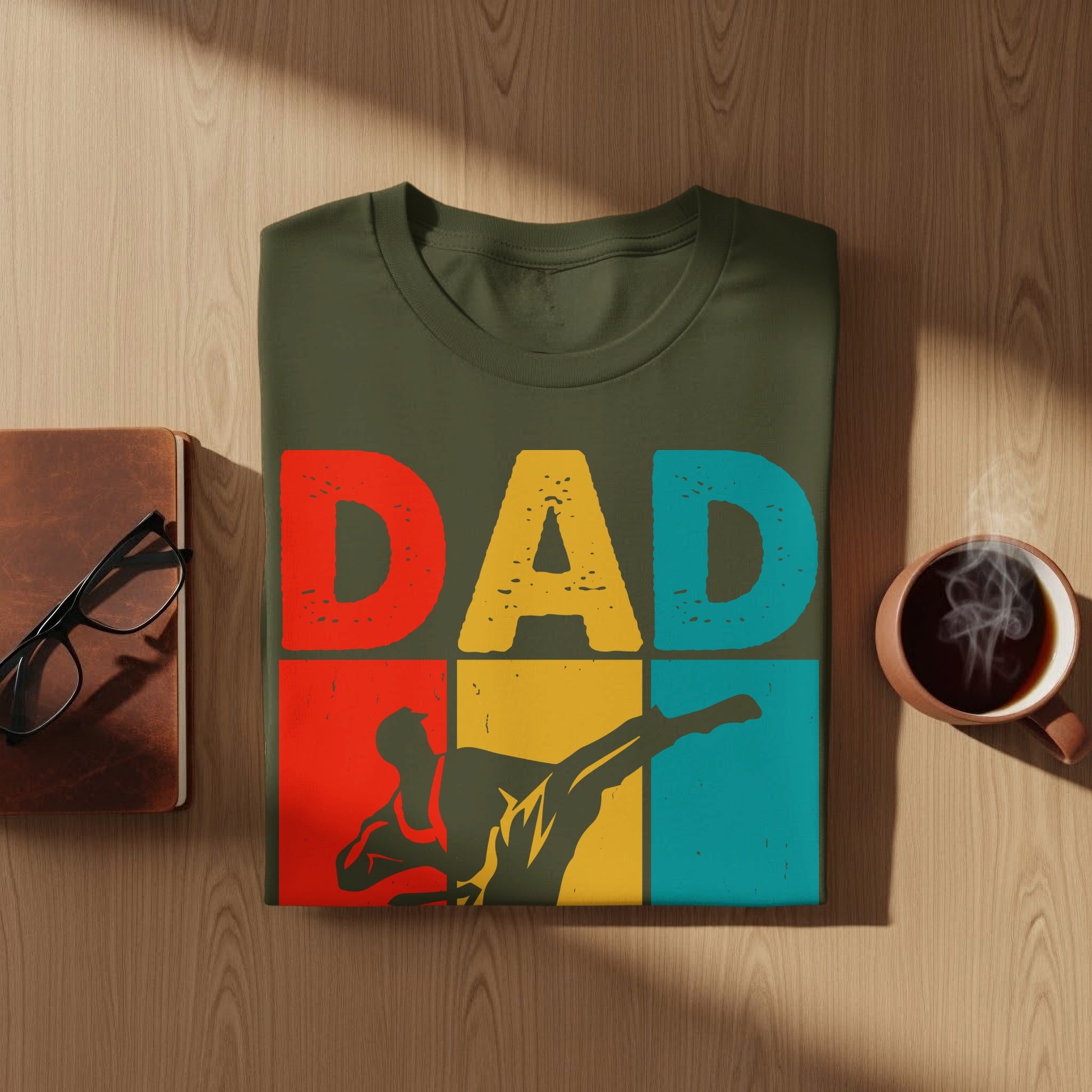 Olive green t-shirt with "DAD" and a silhouette of a person kicking.