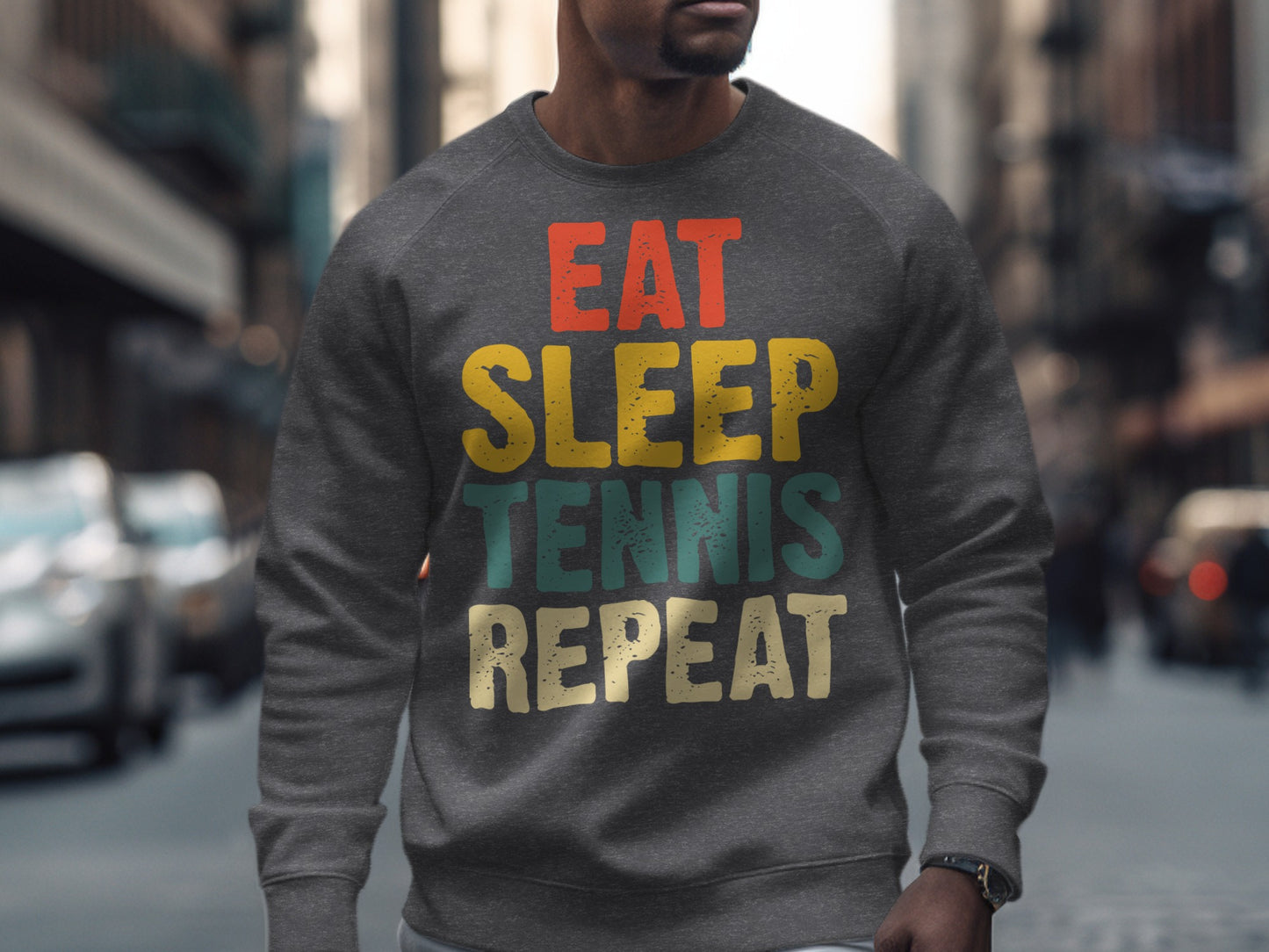 Gray sweatshirt with "EAT SLEEP TENNIS REPEAT" text in colorful block letters.