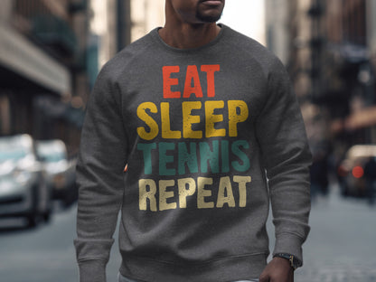 Gray sweatshirt with "EAT SLEEP TENNIS REPEAT" text in colorful block letters.