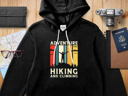 Black Gildan hoodie with "Adventure Hiking and Climbing" graphic.