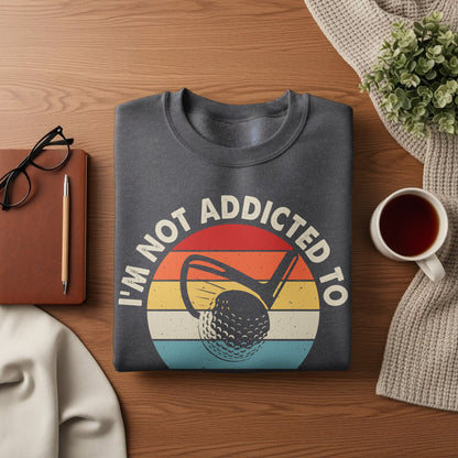 Dark grey sweatshirt with "I'm not addicted to golf" text and golf ball graphic.