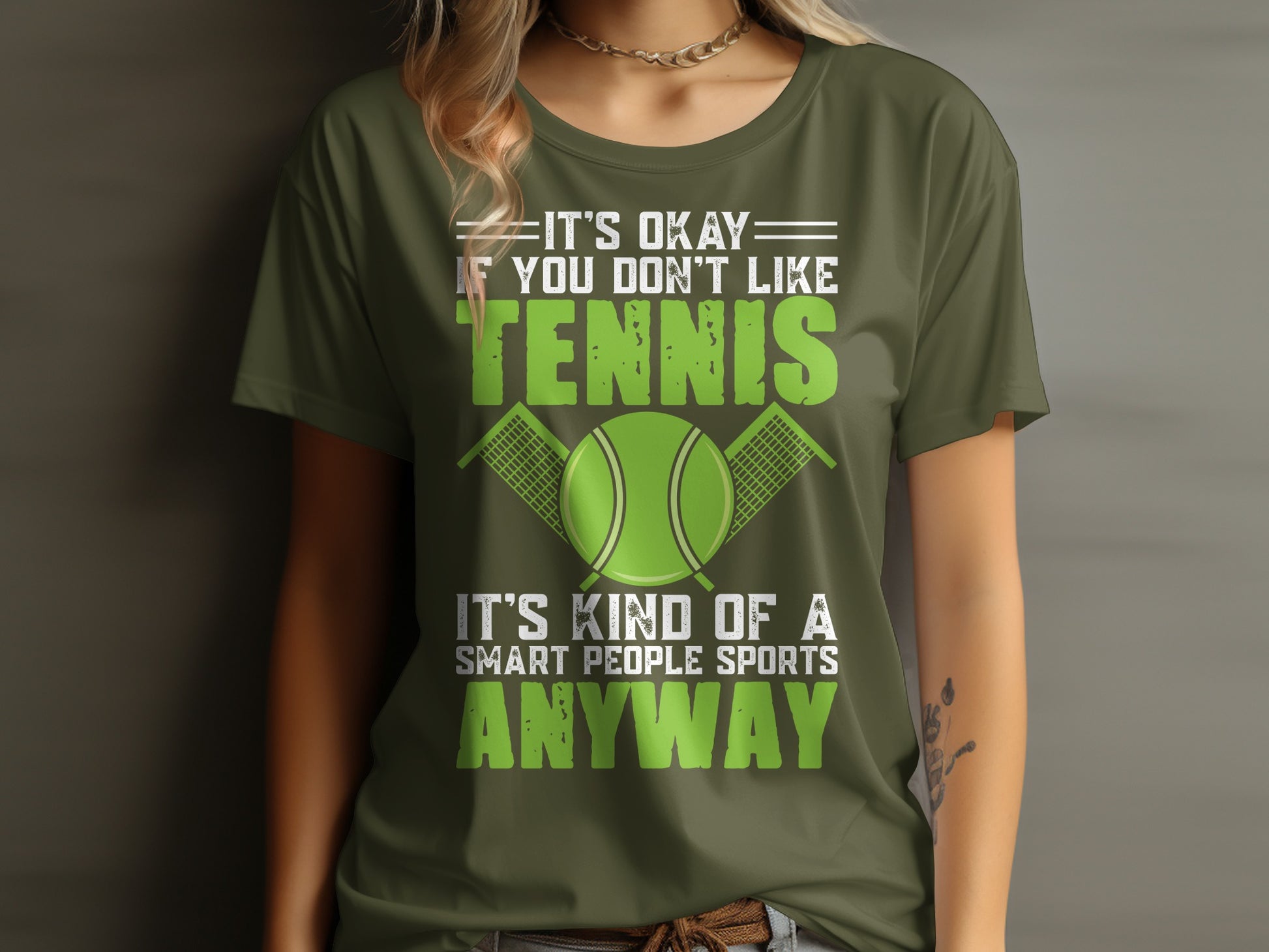 Olive green t-shirt with "It's okay if you don't like tennis, it's kind of a smart people sports anyway" text.