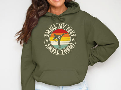 Green hoodie with circular graphic: "Smell My Feet, Smell Them!"