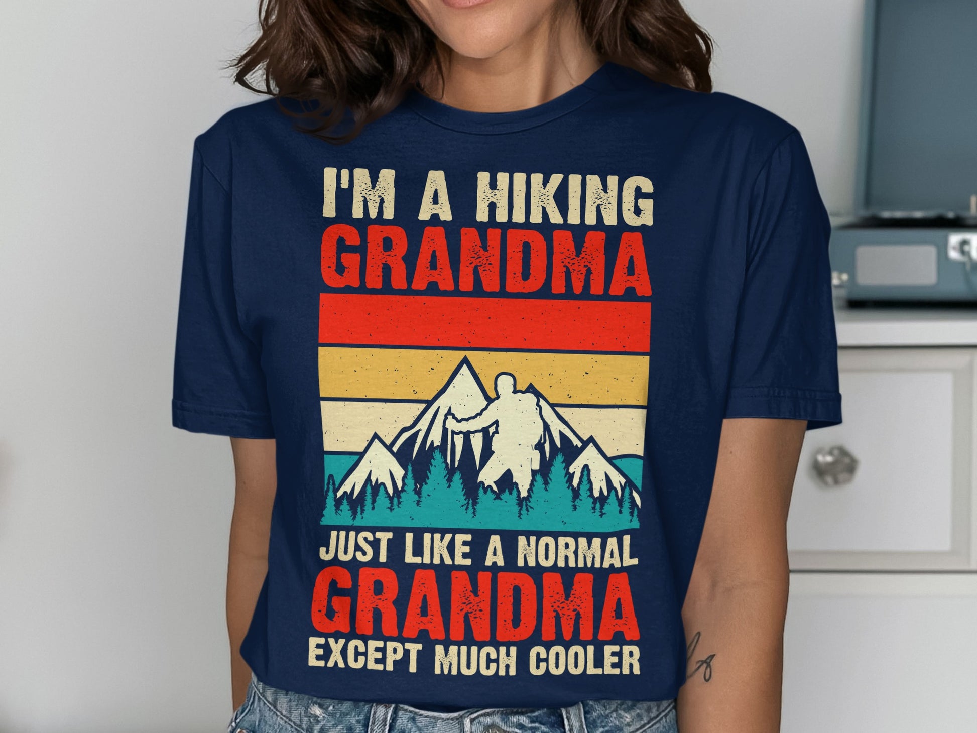 Hiking grandma t-shirt with mountains and vintage stripes, text reads "I'm a hiking grandma...except much cooler."
