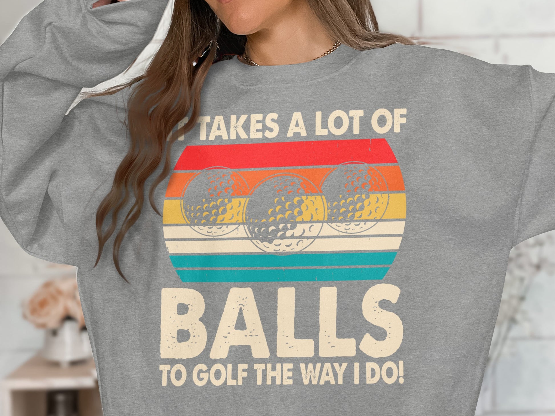 Gray sweatshirt with vintage golf balls and text "Takes a lot of balls to golf the way I do!"