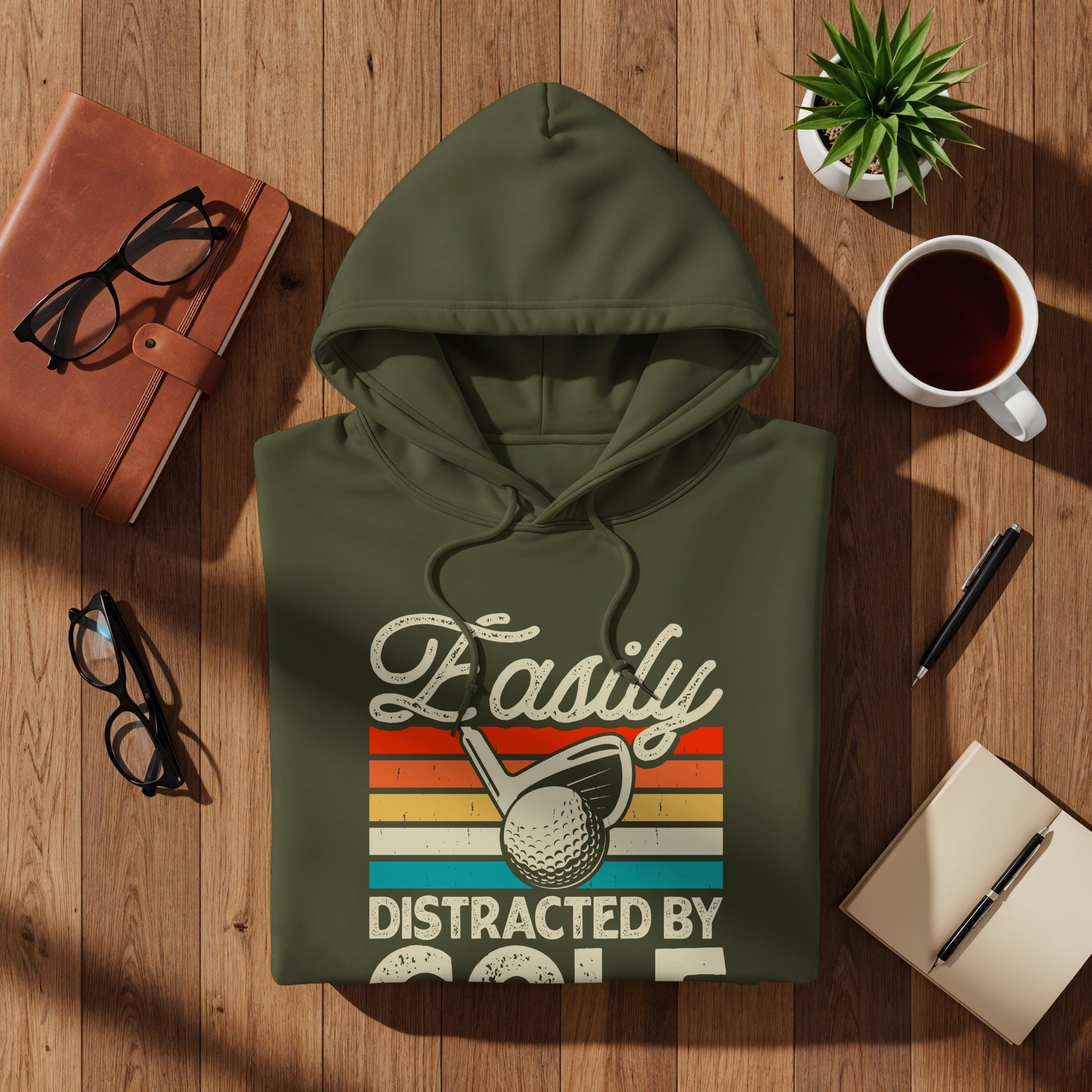 Green hoodie with "Easily Distracted By Golf" text and golf club.