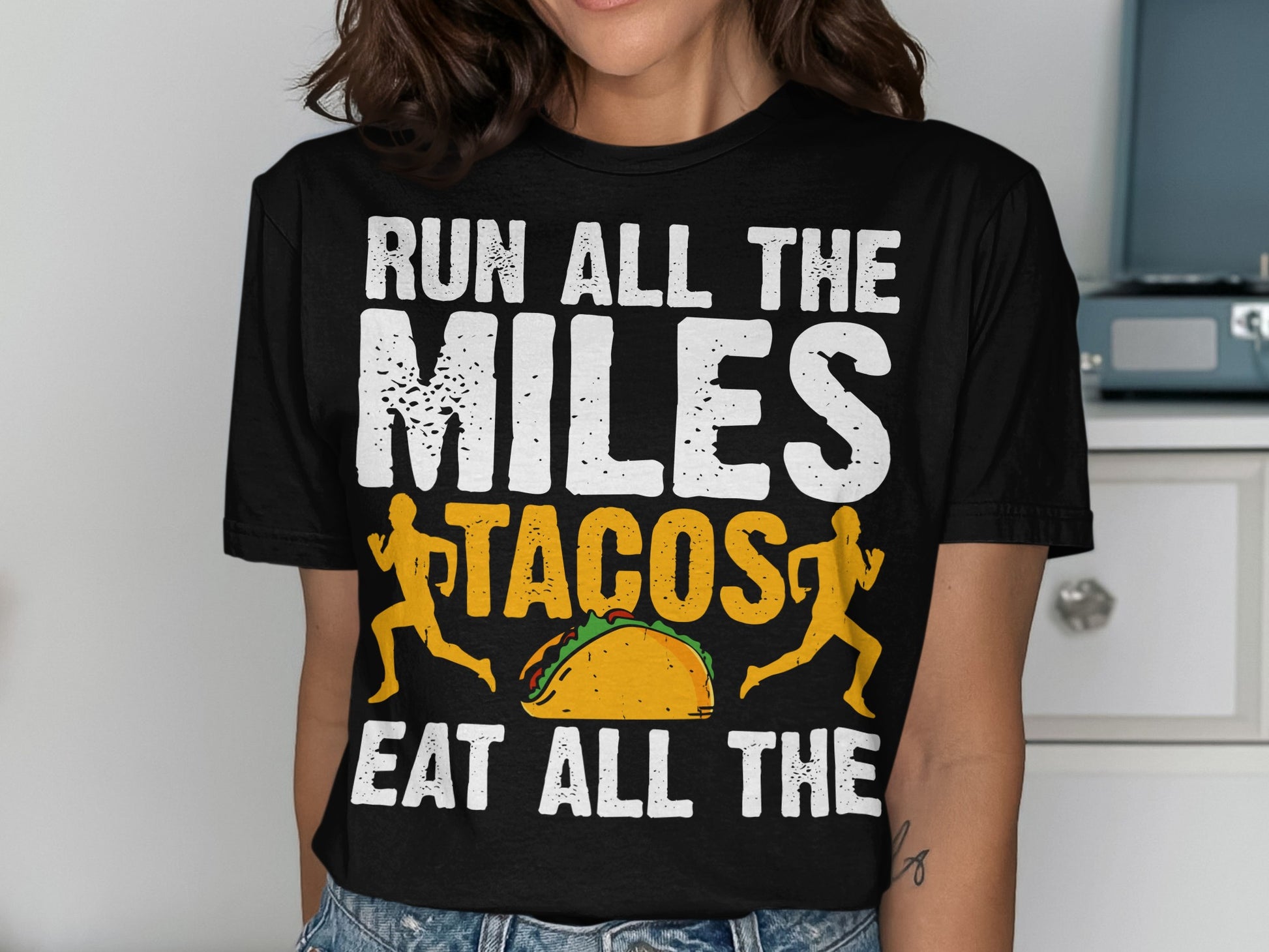 Black t-shirt with "Run All the Miles Eat All the Tacos" and taco graphic.