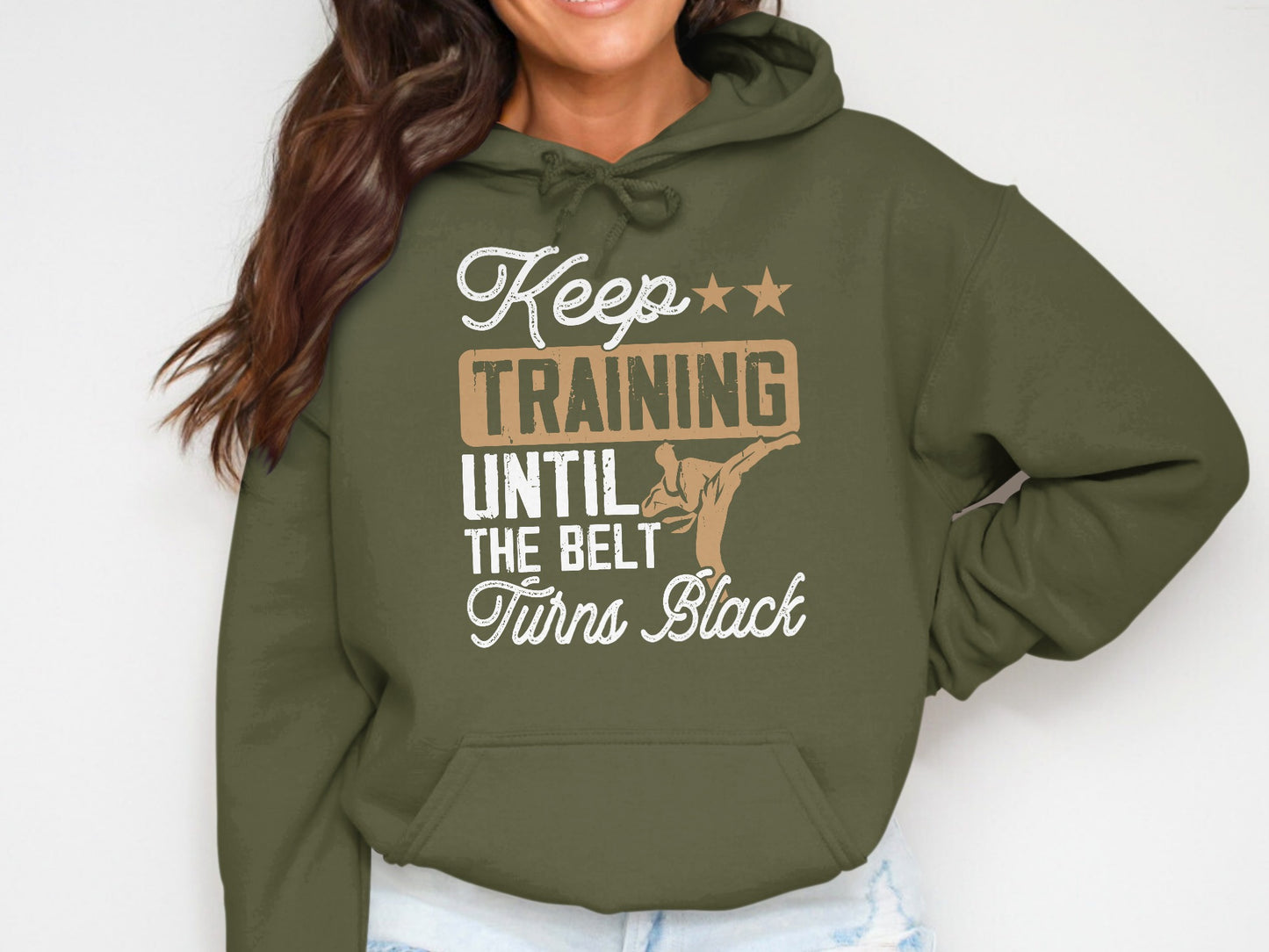 Olive green hoodie with "Keep training until the belt turns black" text and karate graphic.