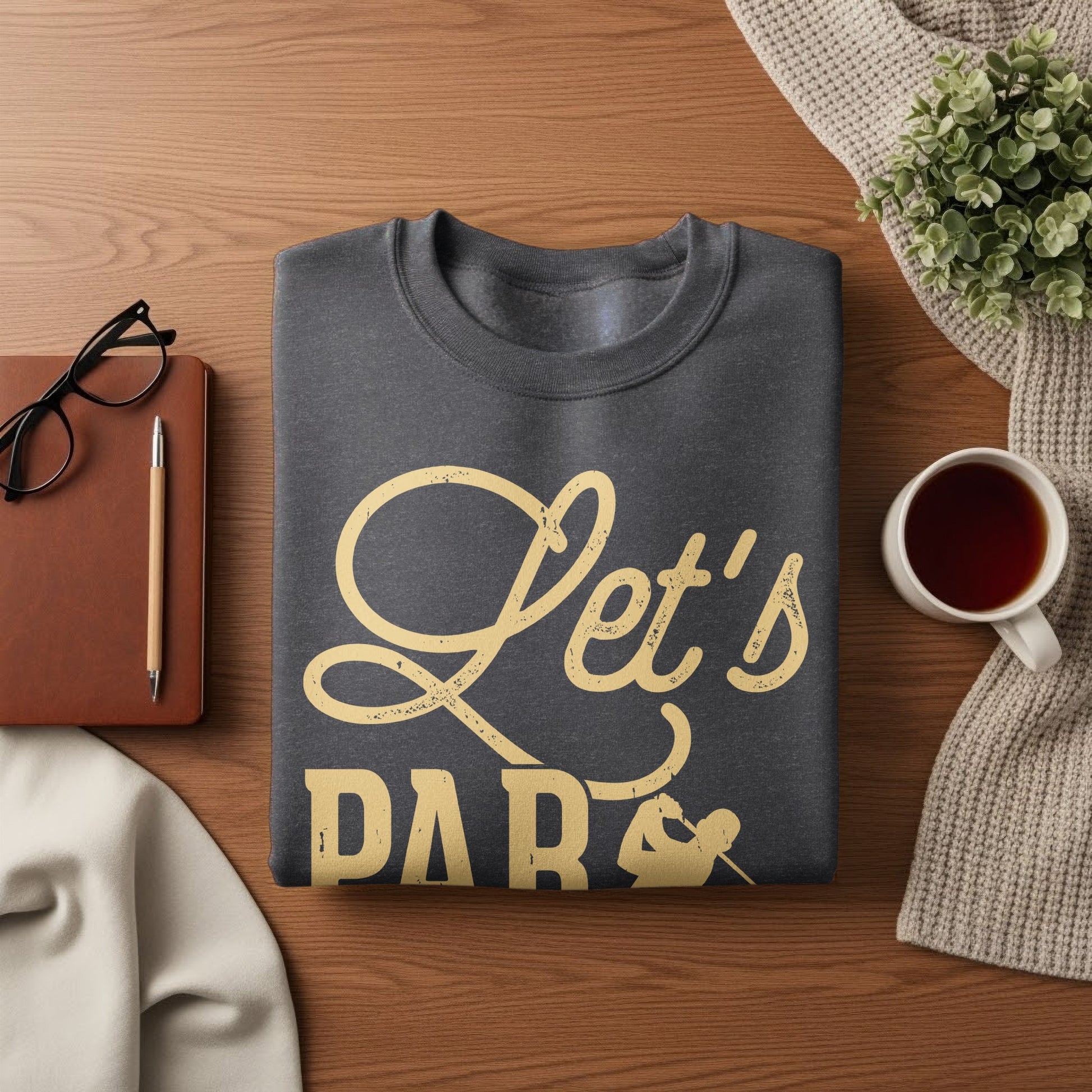 Dark grey sweatshirt with "Let's Party" text in yellow script.