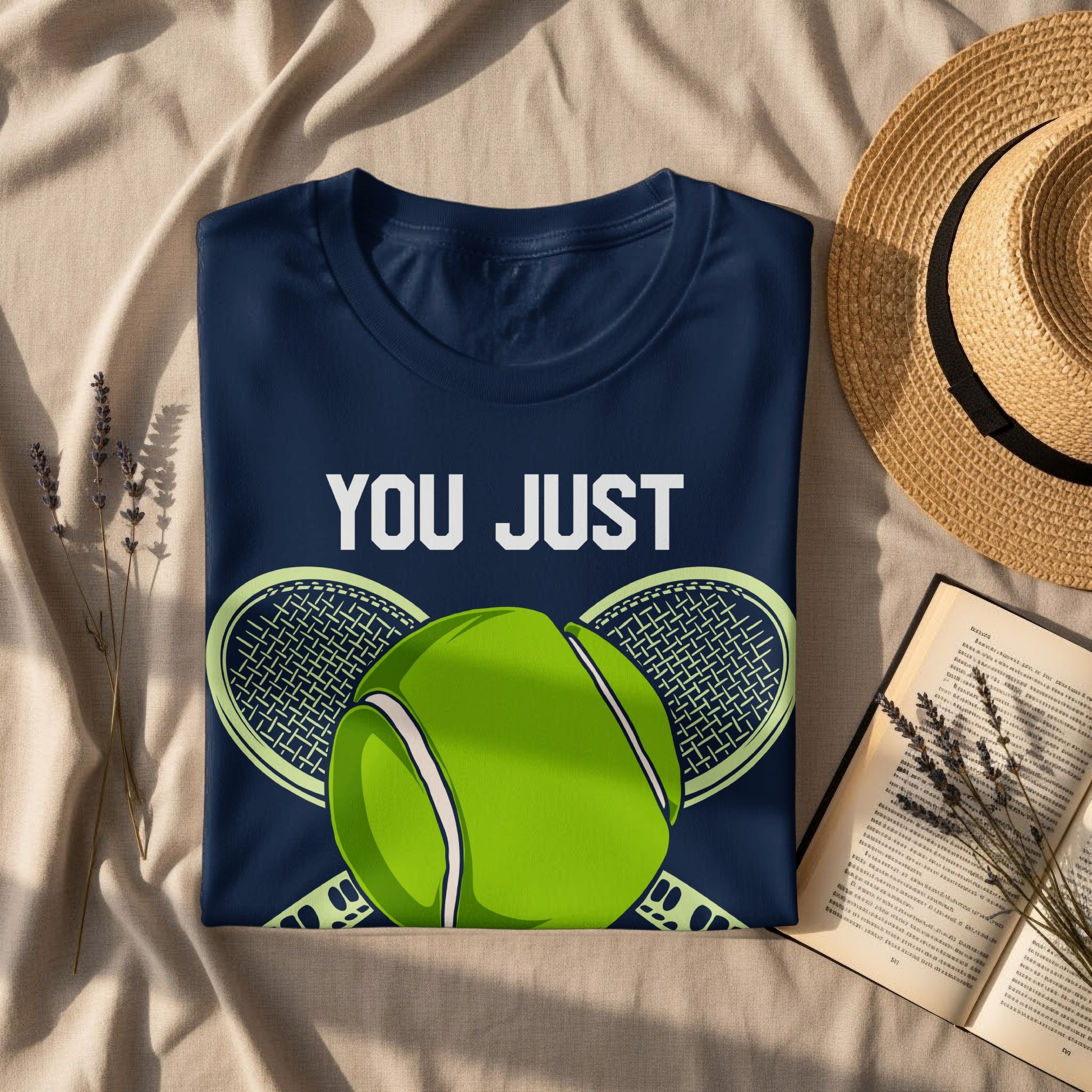 Navy t-shirt with "YOU JUST" above a tennis ball and rackets.