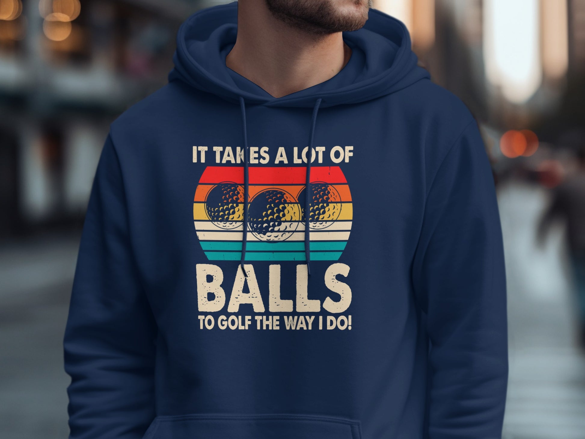 Navy hoodie with "It takes a lot of balls to golf the way I do!" text and golf balls.