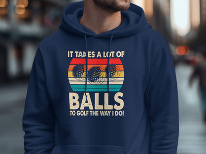 Navy hoodie with "It takes a lot of balls to golf the way I do!" text and golf balls.