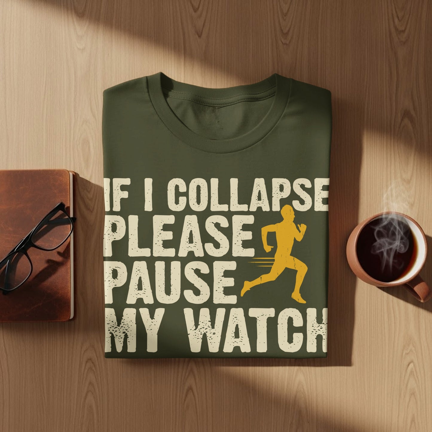 Green t-shirt with "If I collapse please pause my watch" text and runner graphic.