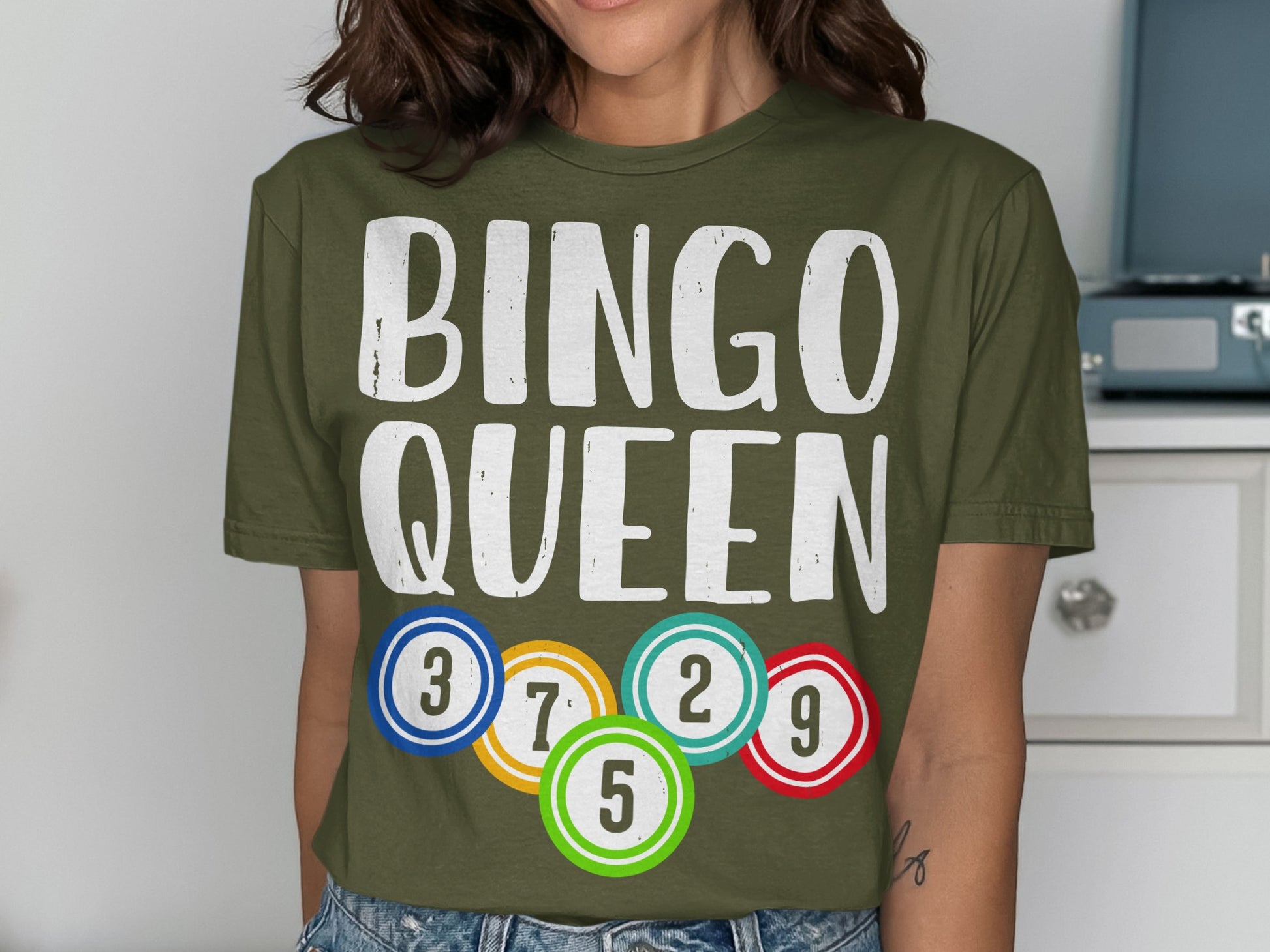 Olive green t-shirt with "BINGO QUEEN" and colorful bingo balls.