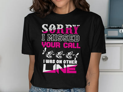 Black t-shirt with pink and white text: "SORRY I MISSED YOUR CALL I WAS ON OTHER LINE" and three fish.
