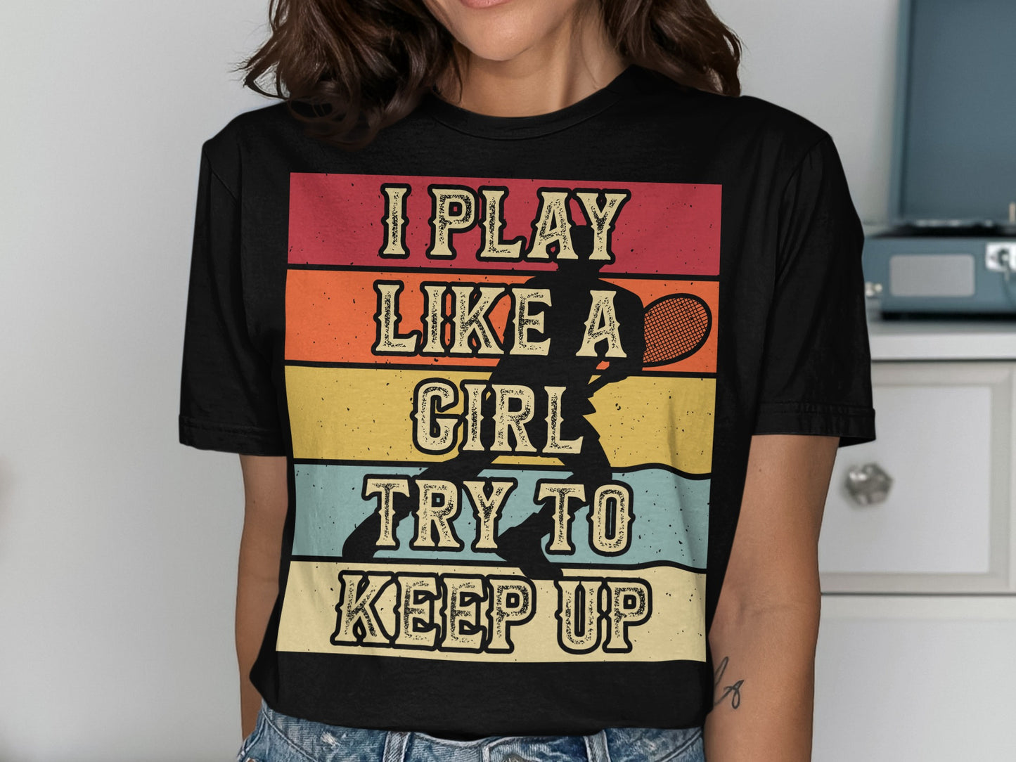 Black t-shirt with "I play like a girl try to keep up" and tennis silhouette.
