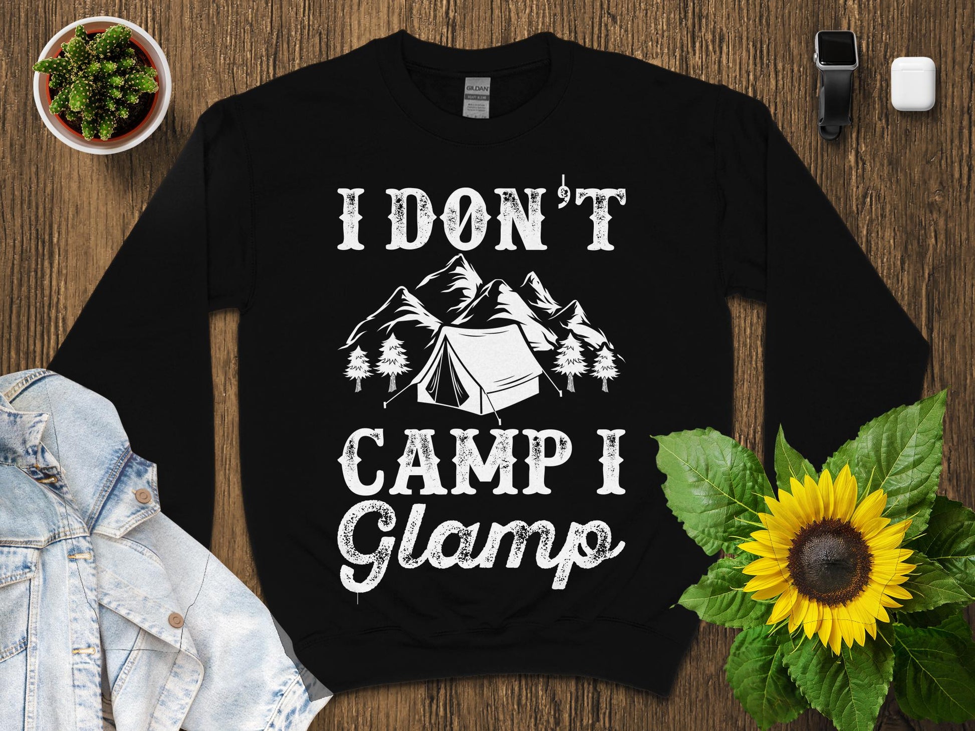 Black sweatshirt with "I don't camp I glamp" text and mountain graphic.