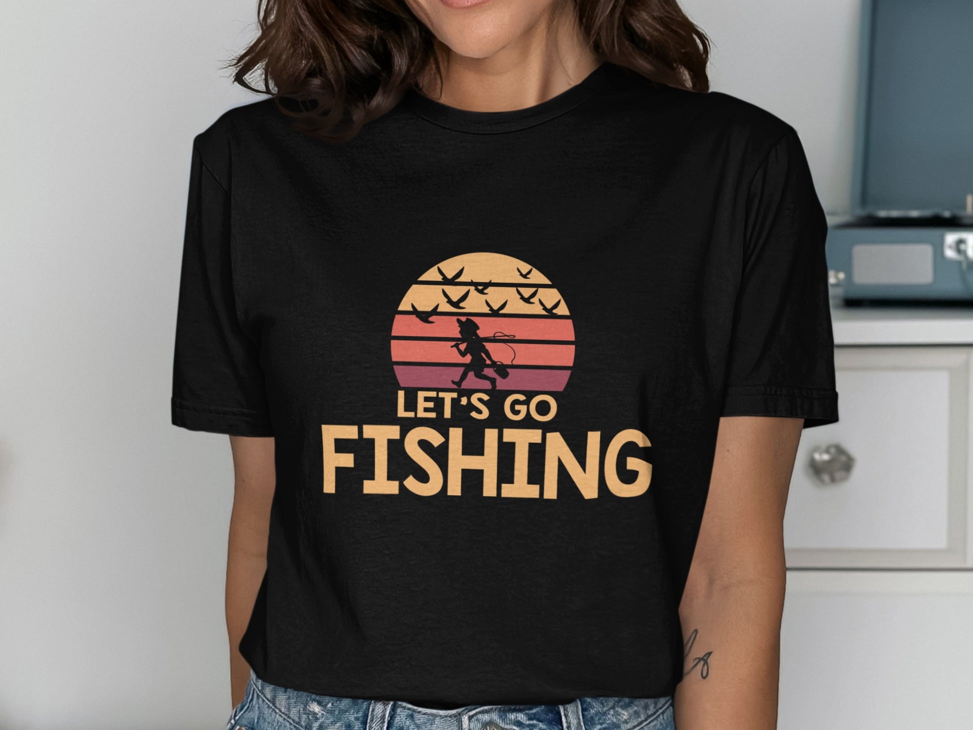 Black t-shirt with "Let's Go Fishing" text and fishing silhouette.