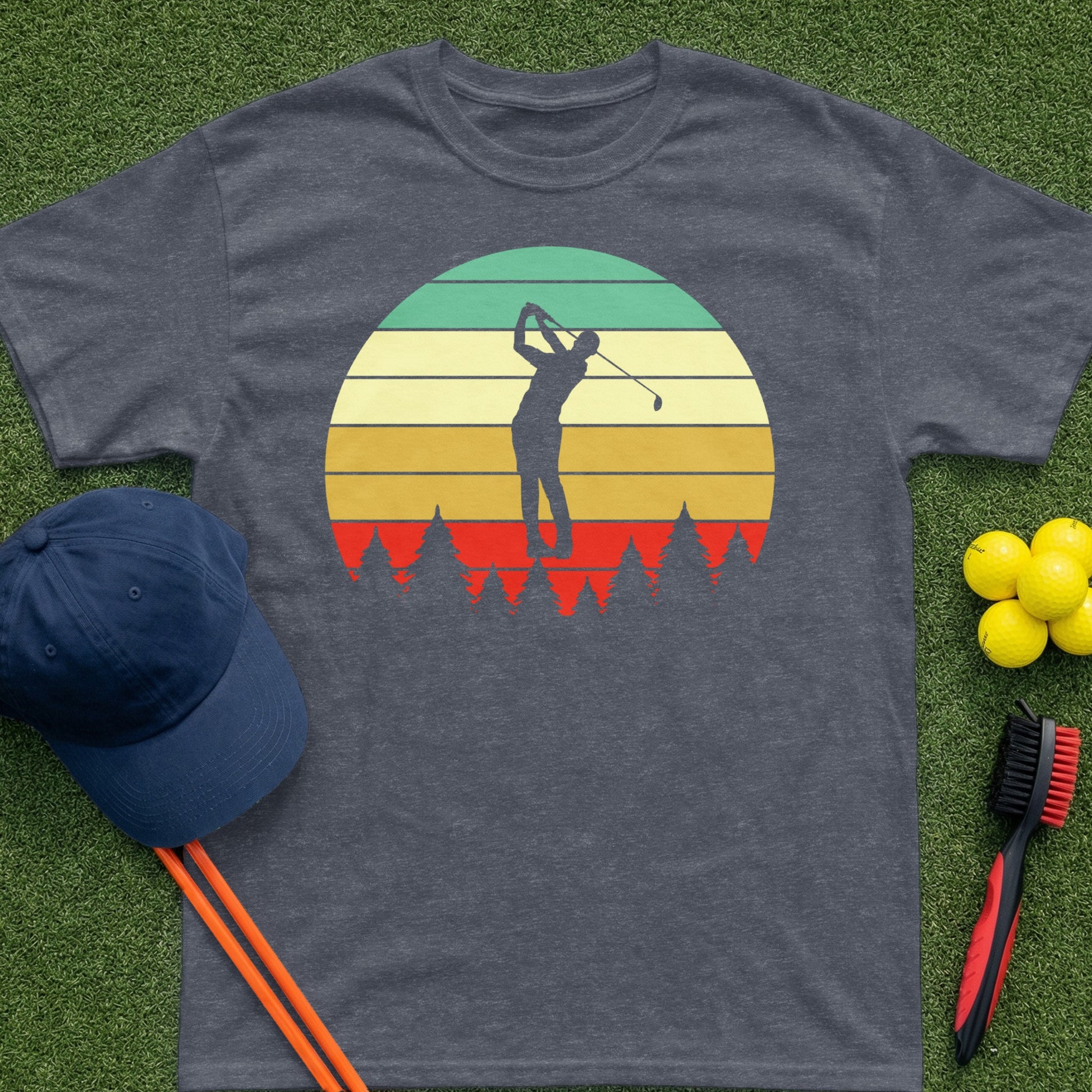 T-shirt with golfer silhouette against a sunset and trees.