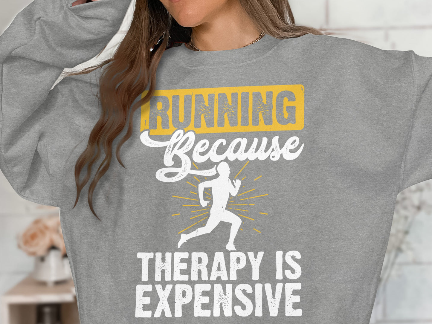 Grey sweatshirt with "Running Because Therapy Is Expensive" and running silhouette.