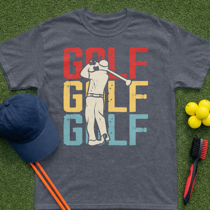 Golf graphic tee with golfer swinging, green grass, blue hat, and golf balls.