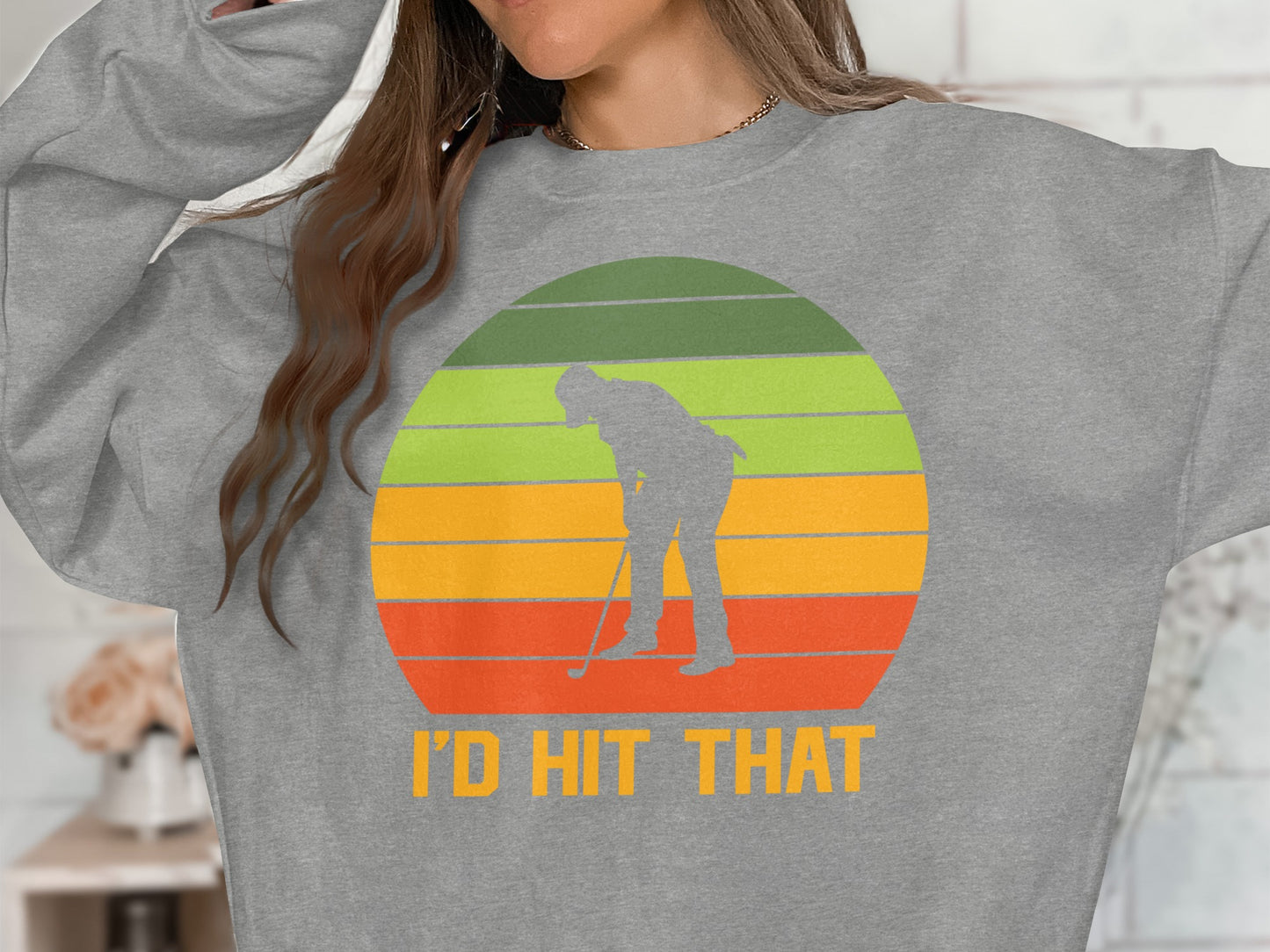 Gray sweatshirt with golfer silhouette on sunset graphic and text "I'D HIT THAT".