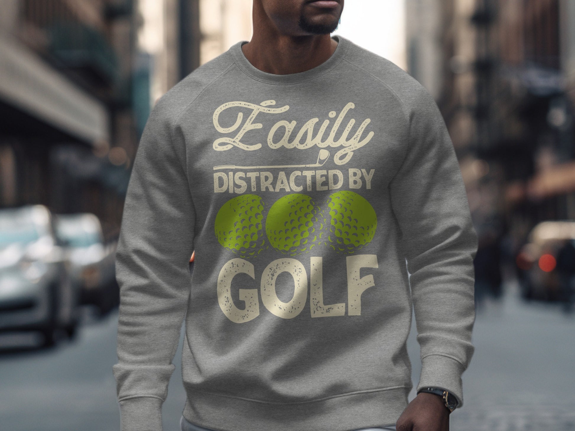 Gray sweatshirt with "Easily Distracted by Golf" text and three lime green golf balls.