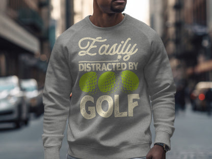 Gray sweatshirt with "Easily Distracted by Golf" text and three lime green golf balls.