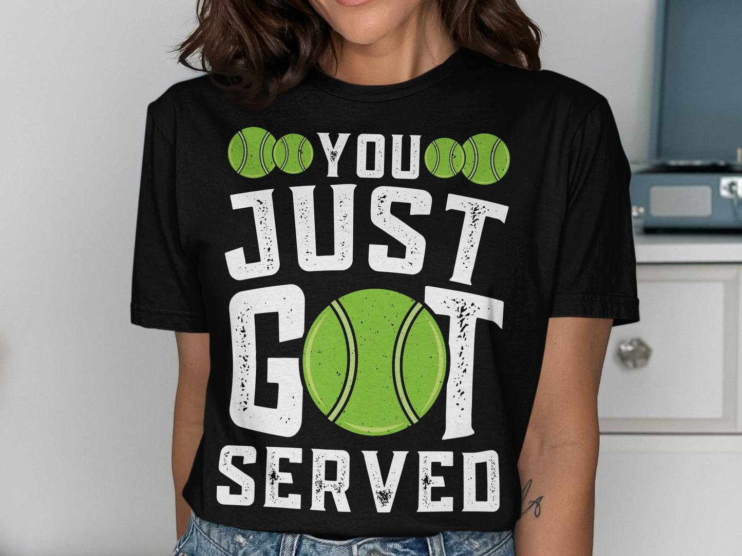 Black t-shirt with green tennis balls and text: "YOU JUST GOT SERVED".