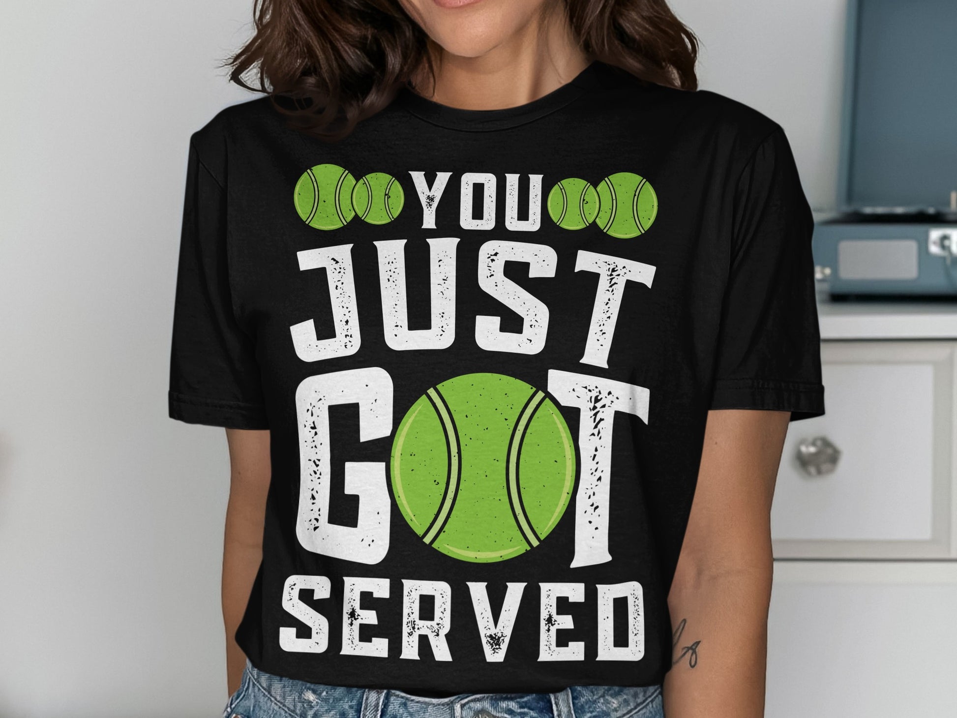 Black t-shirt with green tennis balls and text: "YOU JUST GOT SERVED".