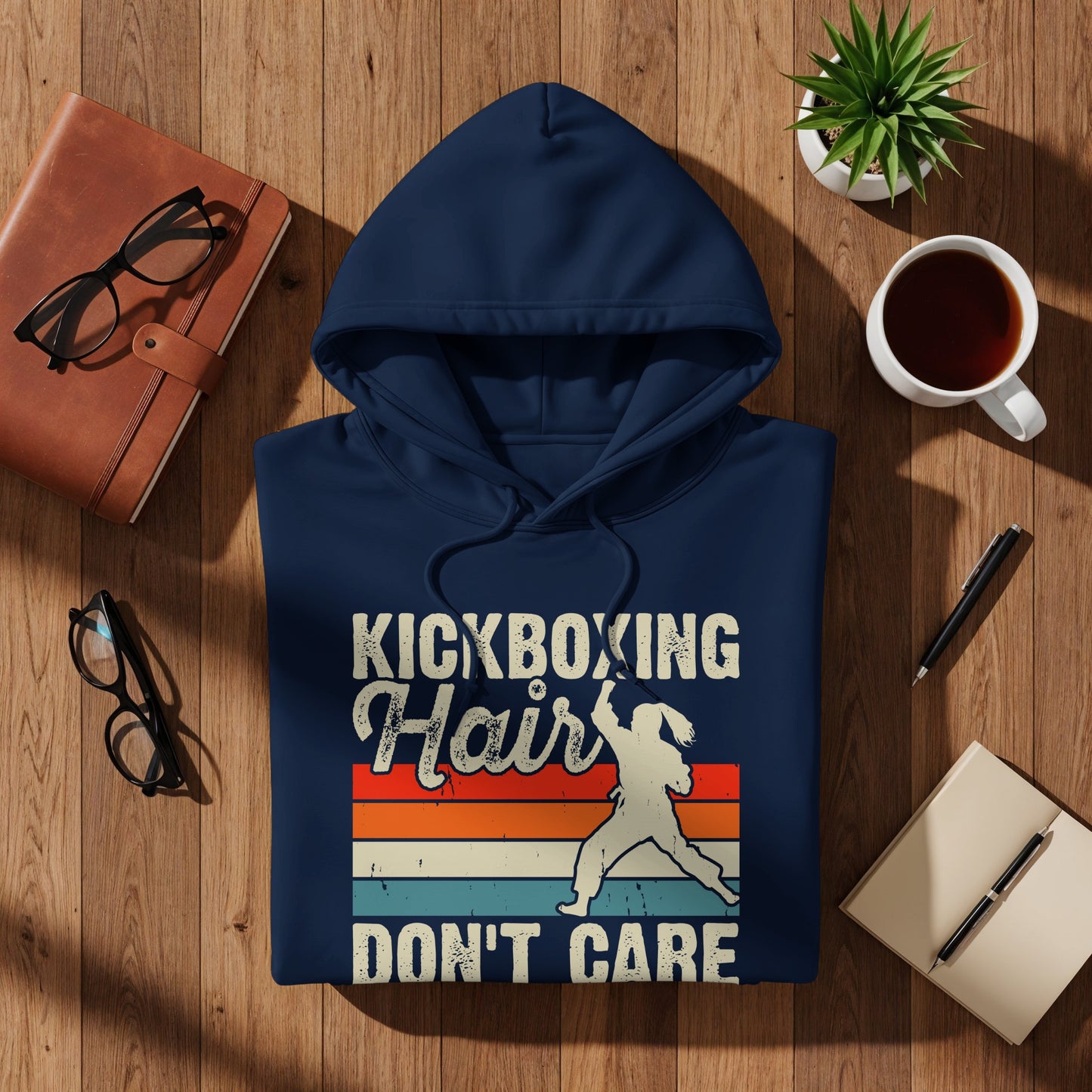 Navy hoodie with "KICKBOXING HAIR DON'T CARE" text and a kickboxer graphic.