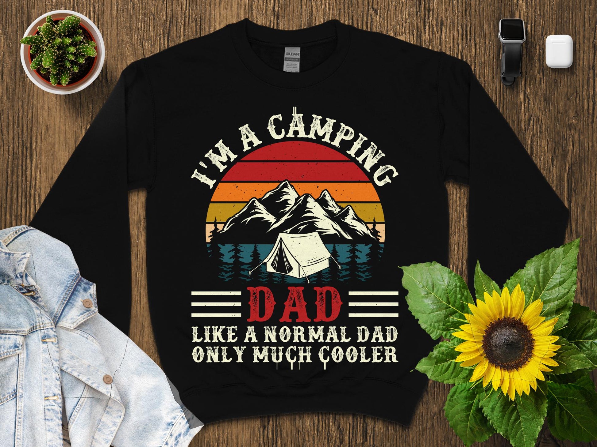 Black sweatshirt with "I'm a camping dad, like a normal dad, only much cooler" text and camping graphic.