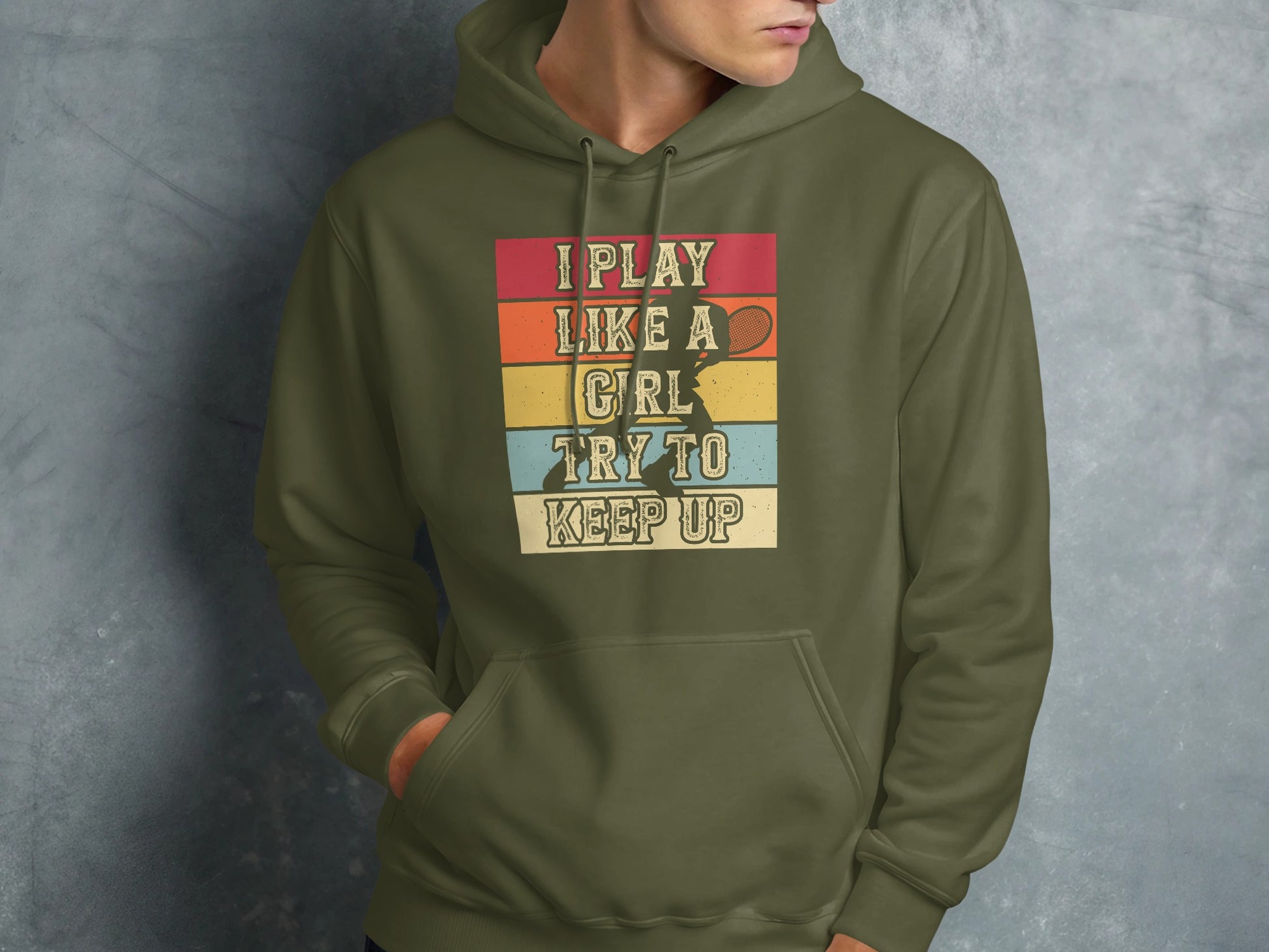 Olive green hoodie with "I Play Like a Girl Try to Keep Up" text and tennis player graphic.