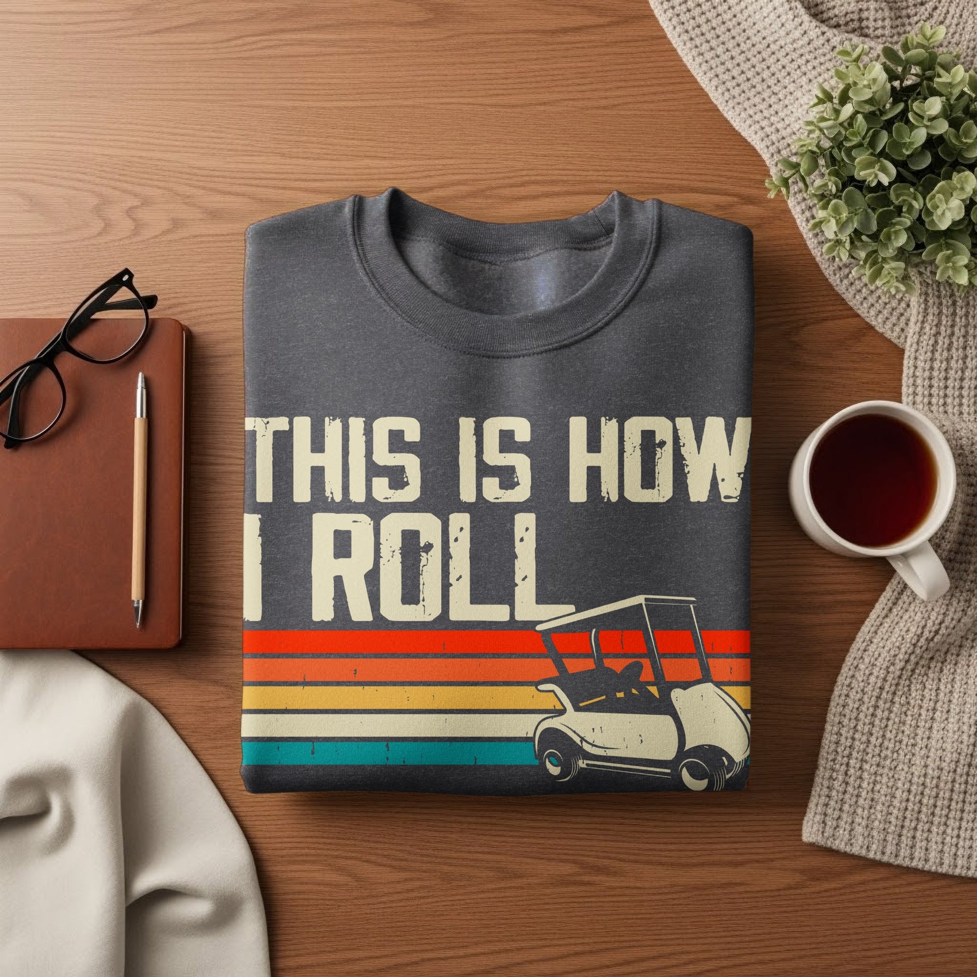 Dark grey crewneck sweatshirt with "THIS IS HOW I ROLL" text and a golf cart graphic.