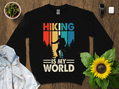 Black sweatshirt with "Hiking is my world" in retro style with hiker silhouette.