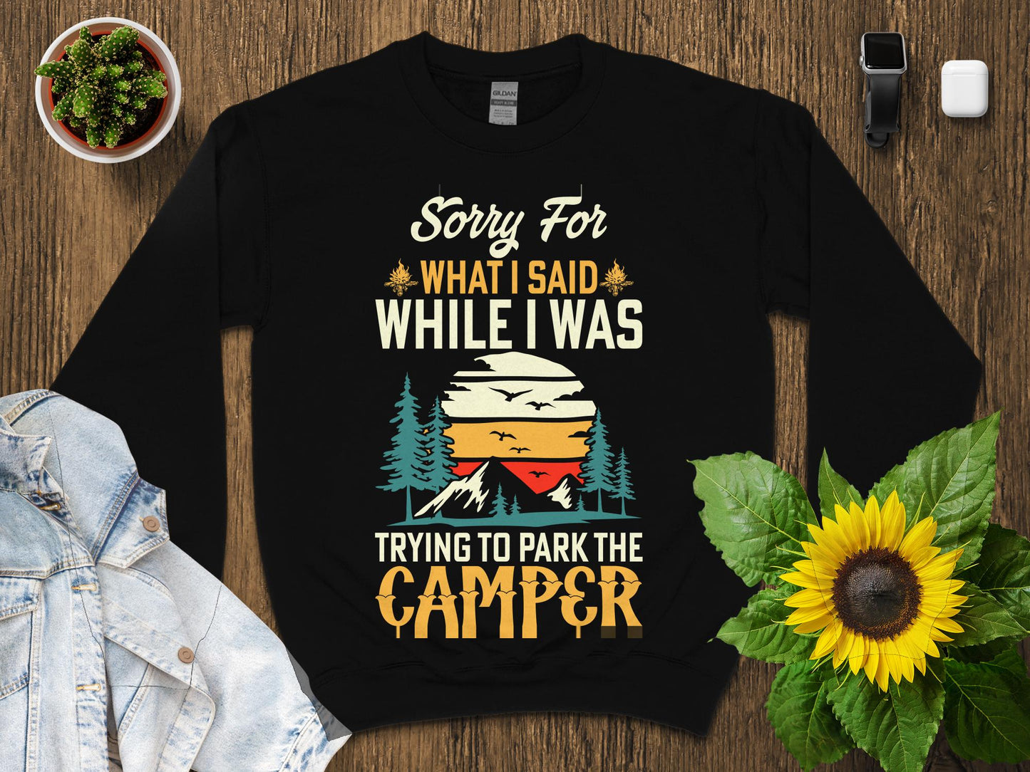 Black sweatshirt with "Sorry for what I said while I was trying to park the camper" text and sunset graphic.