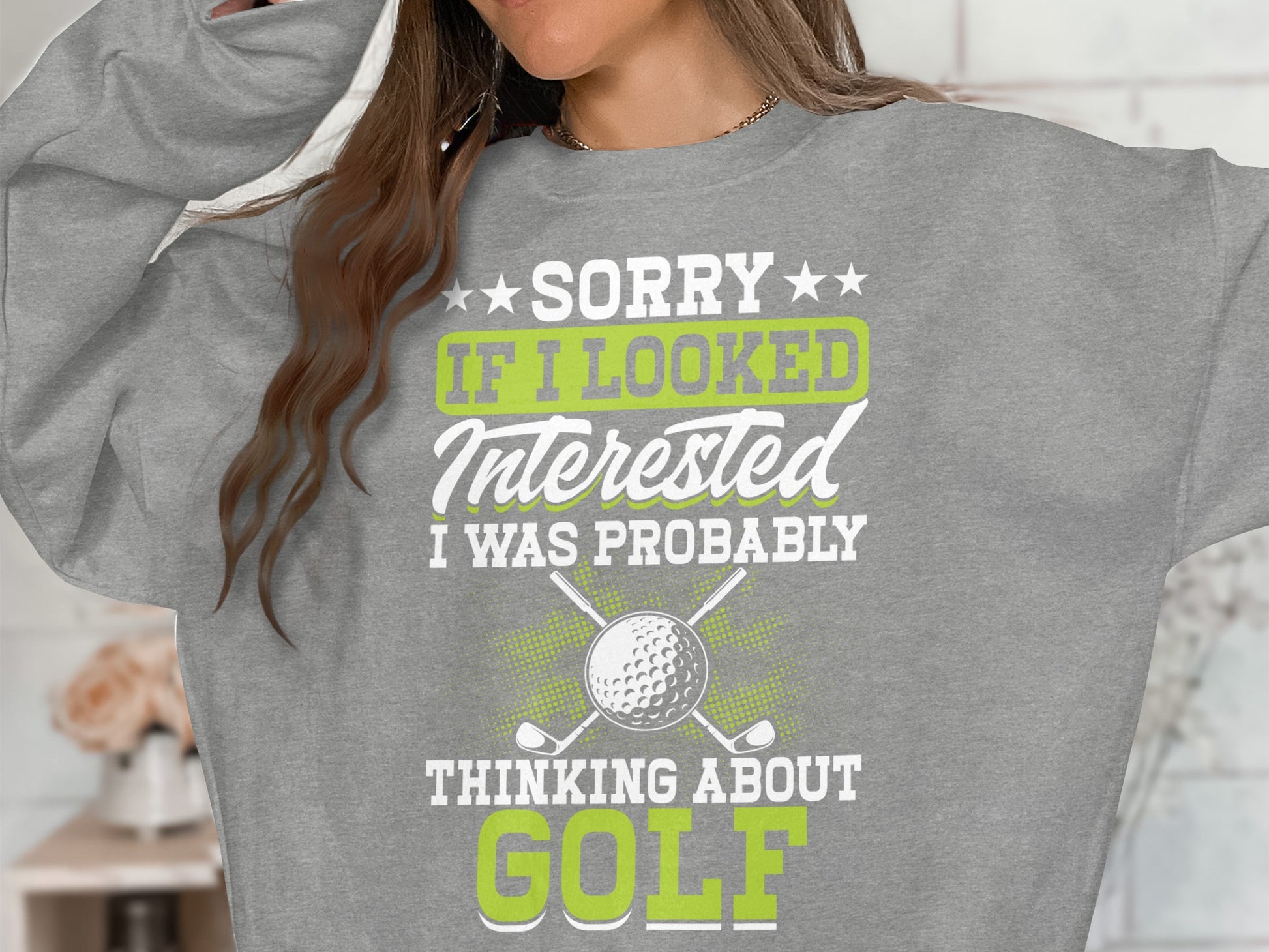 Gray sweatshirt with "SORRY IF I LOOKED INTERESTED I WAS PROBABLY THINKING ABOUT GOLF" text.