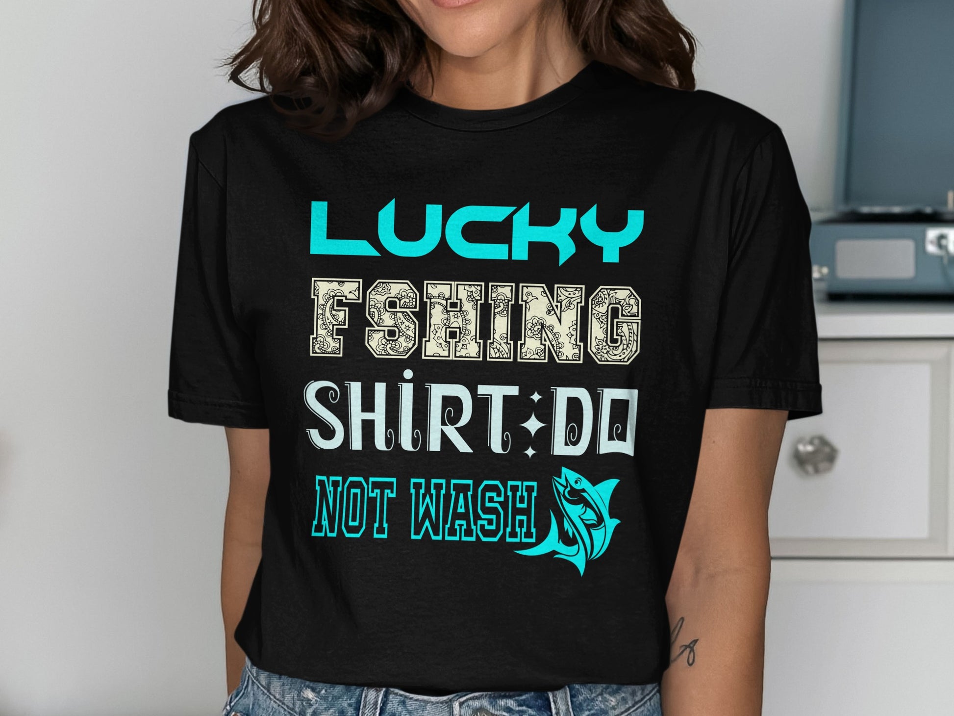 Black t-shirt with "Lucky Fishing Shirt Do Not Wash" text and fish graphic.