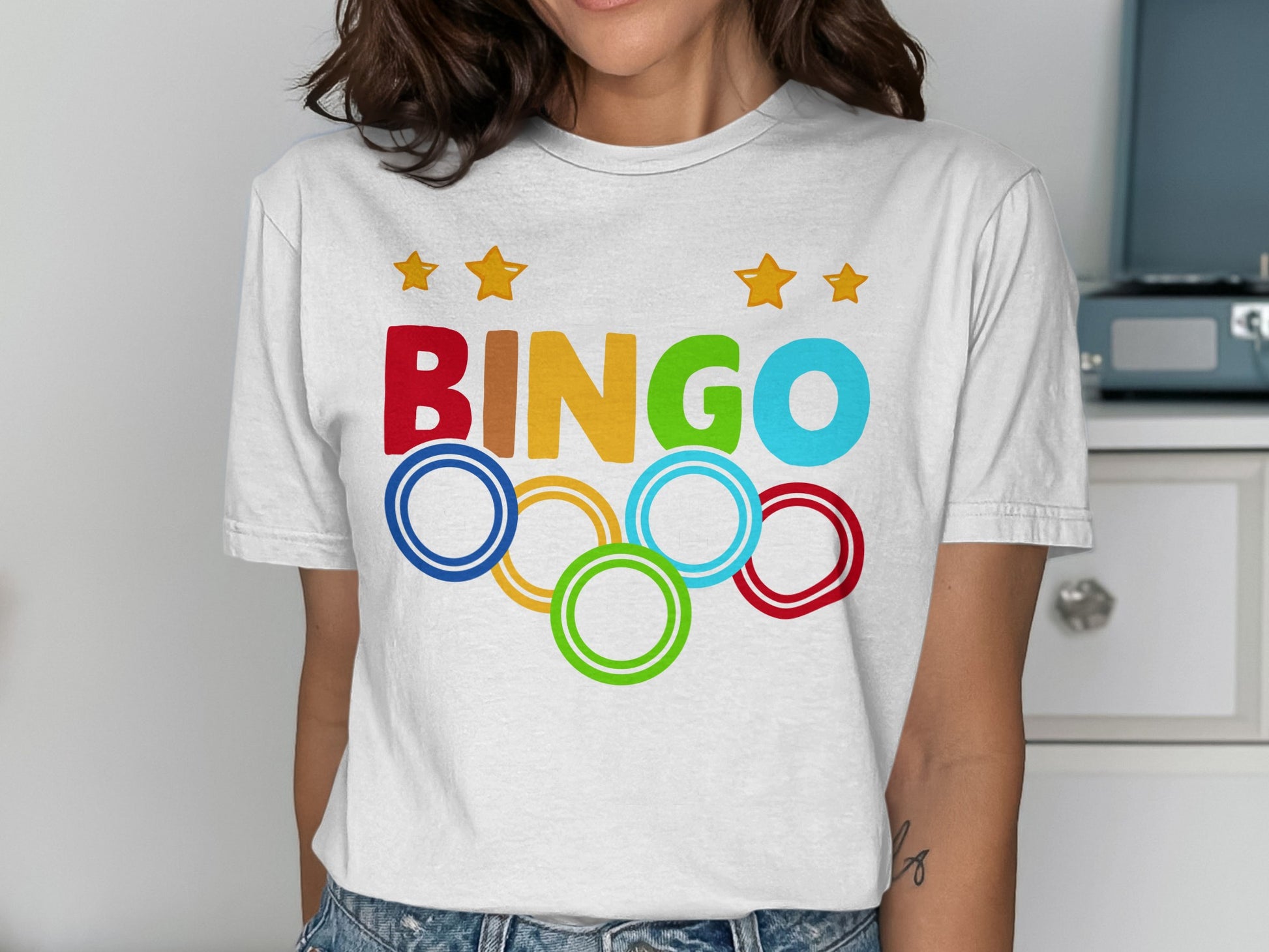 White t-shirt with "BINGO" text and Olympic rings.