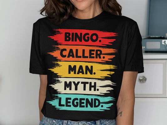 Black t-shirt with "BINGO. CALLER. MAN. MYTH. LEGEND." in colorful brush strokes.