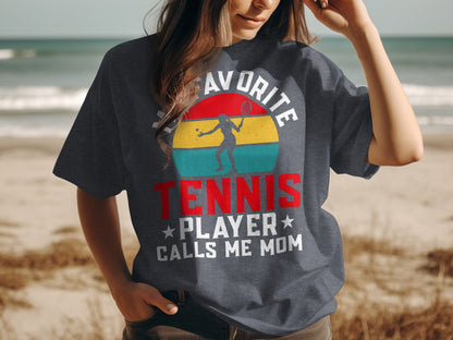 Woman wearing dark t-shirt with "My Favorite Tennis Player Calls Me Mom" slogan.