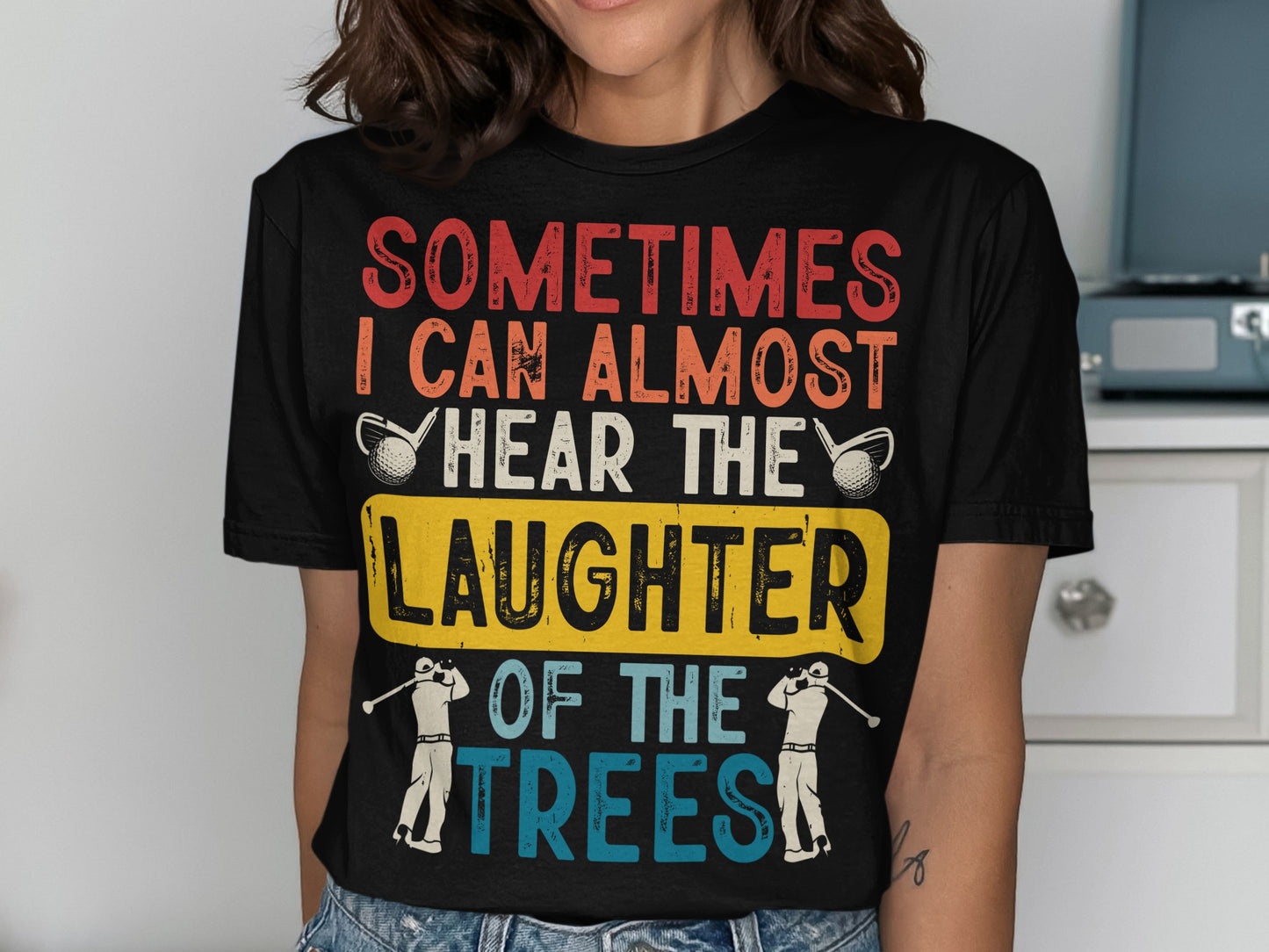 T-shirt with "Sometimes I can almost hear the laughter of the trees" text and golf imagery.