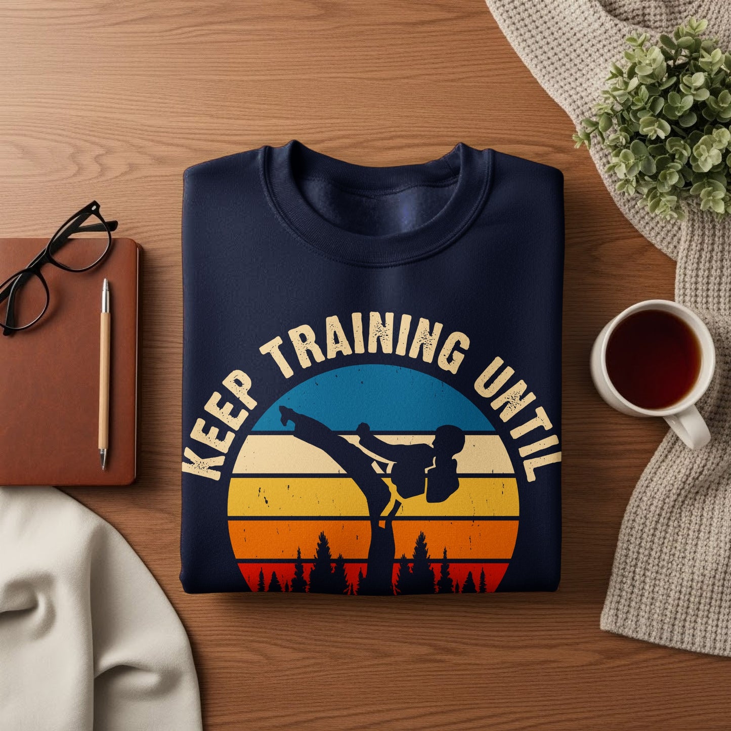 Navy sweatshirt with martial artist silhouette and "Keep Training Until" text.